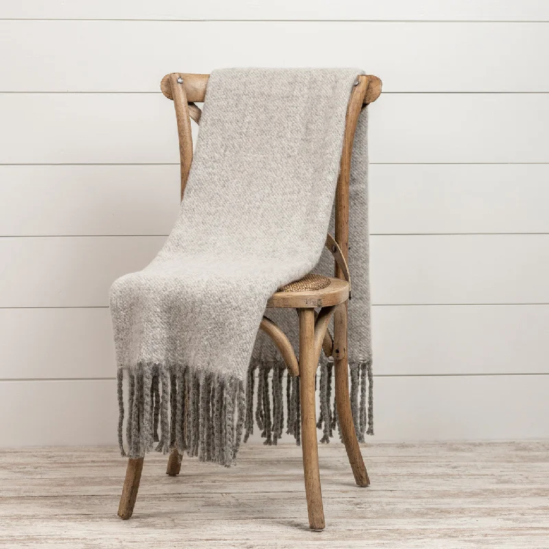 Cotton blankets for breathability and a lightweight feelHeathered Grey Throw With Tassels